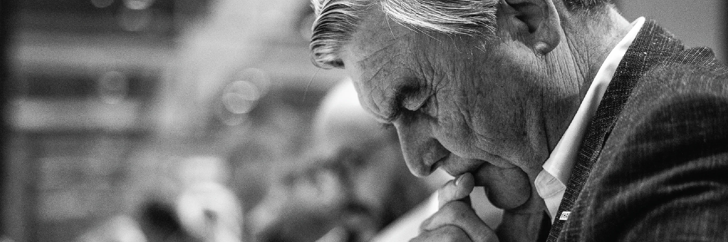 Black and white candid of an attendee deep in thought