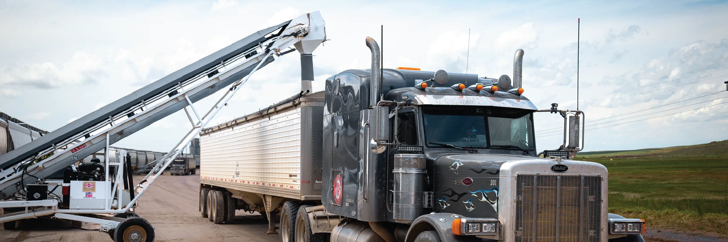 Truck and conveyor at a well site