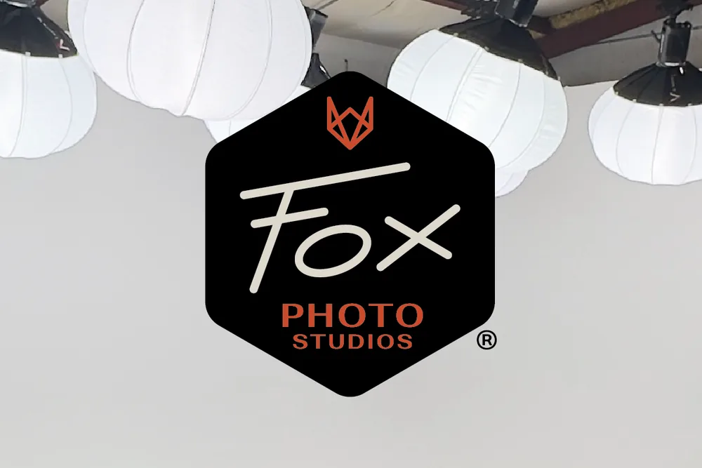 Fox Photo Studios badge over the studio cyc wall and lantern lights