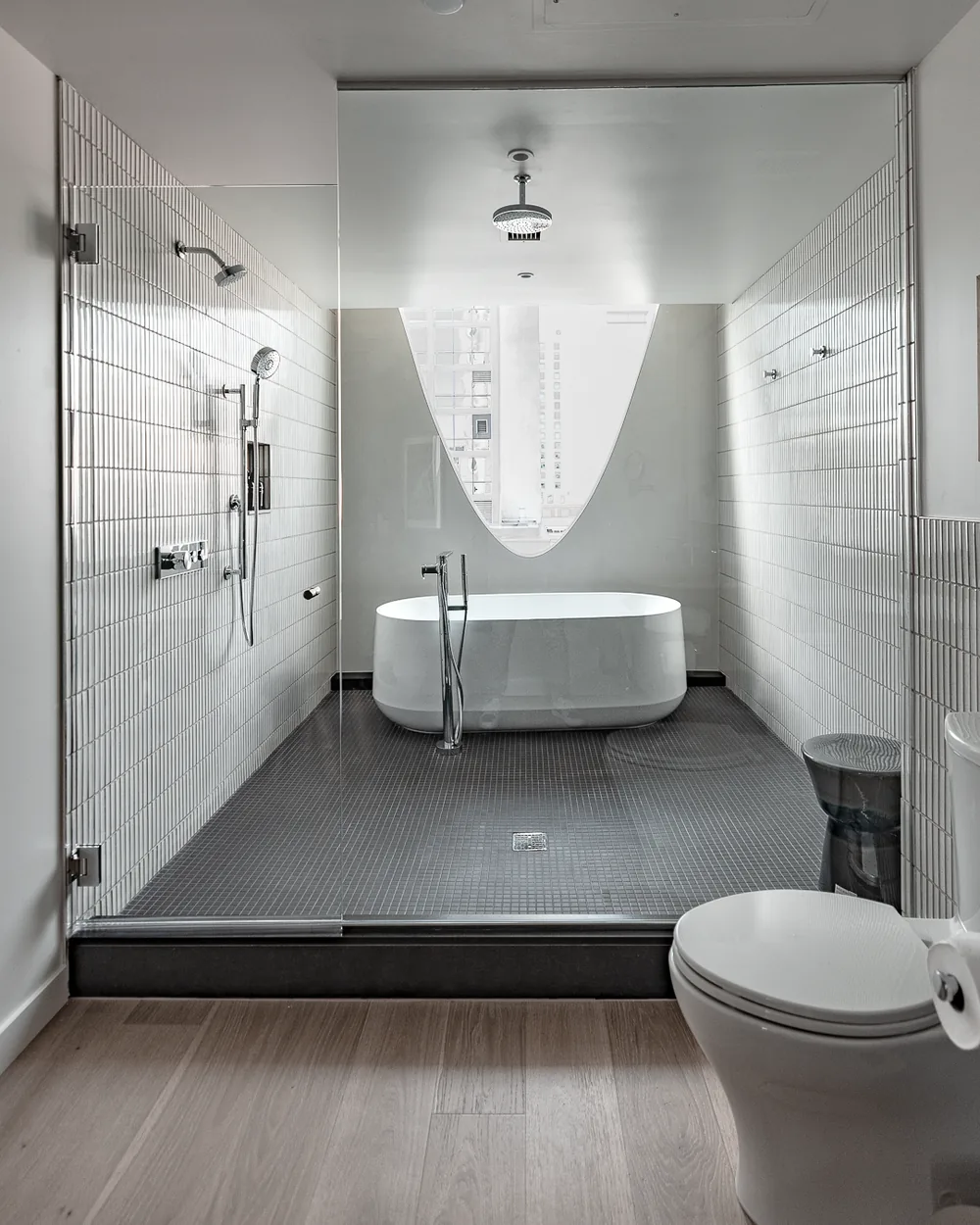 Modern hotel bathroom with freestanding tub and walk-in shower