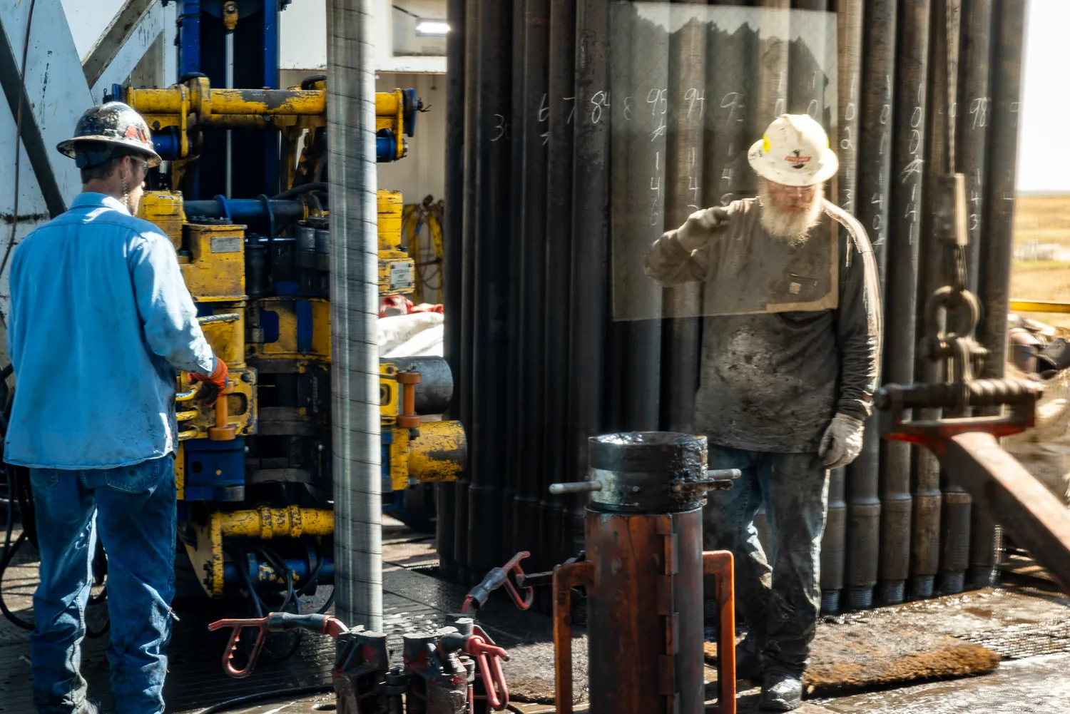 Drilling crew working together on the rig floor