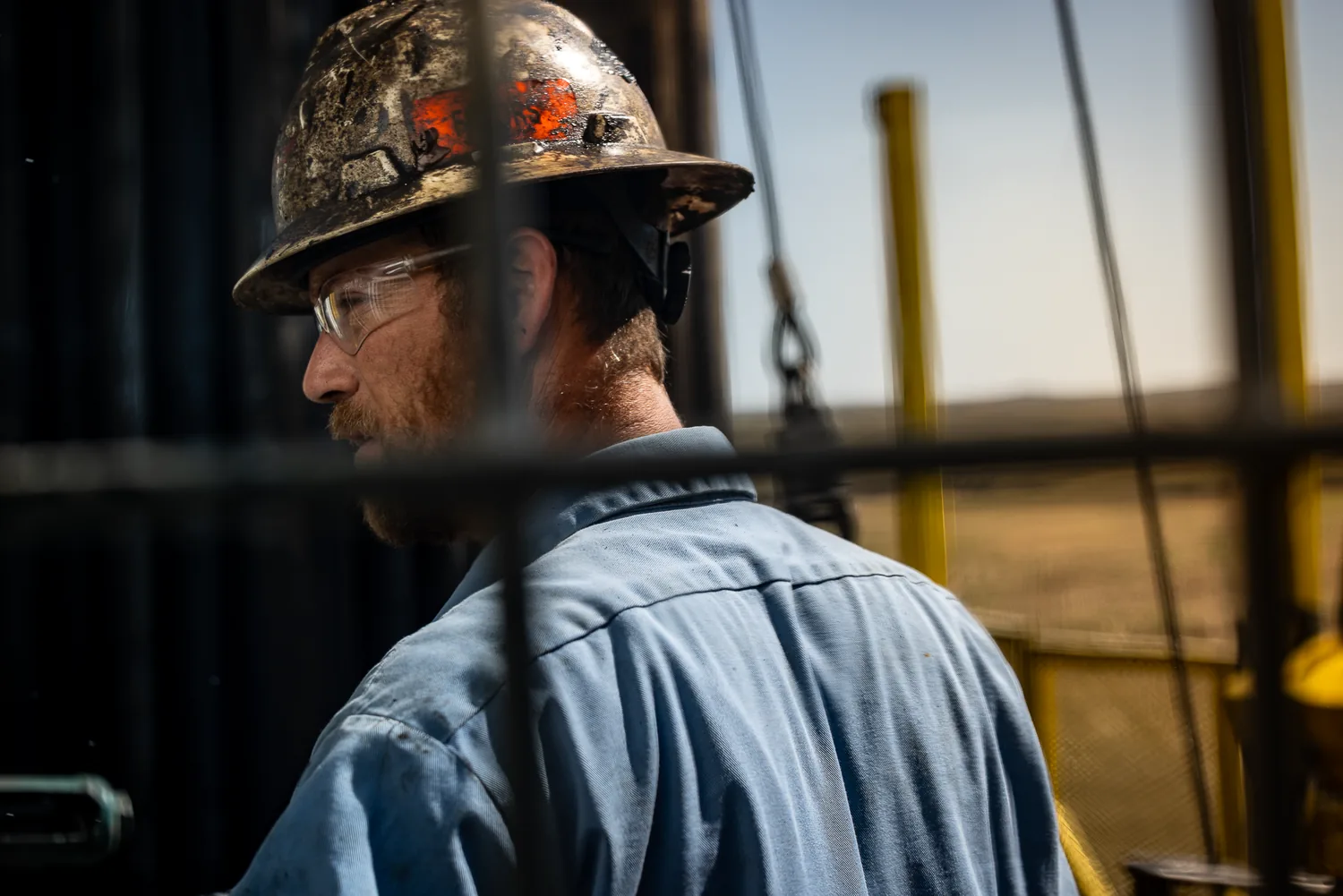 Anschutz Exploration driller in hard hat on the rig, environmental portrait