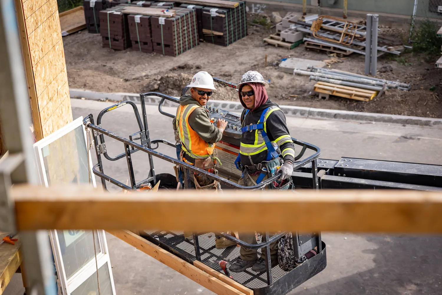 Crew on a lift during window installation