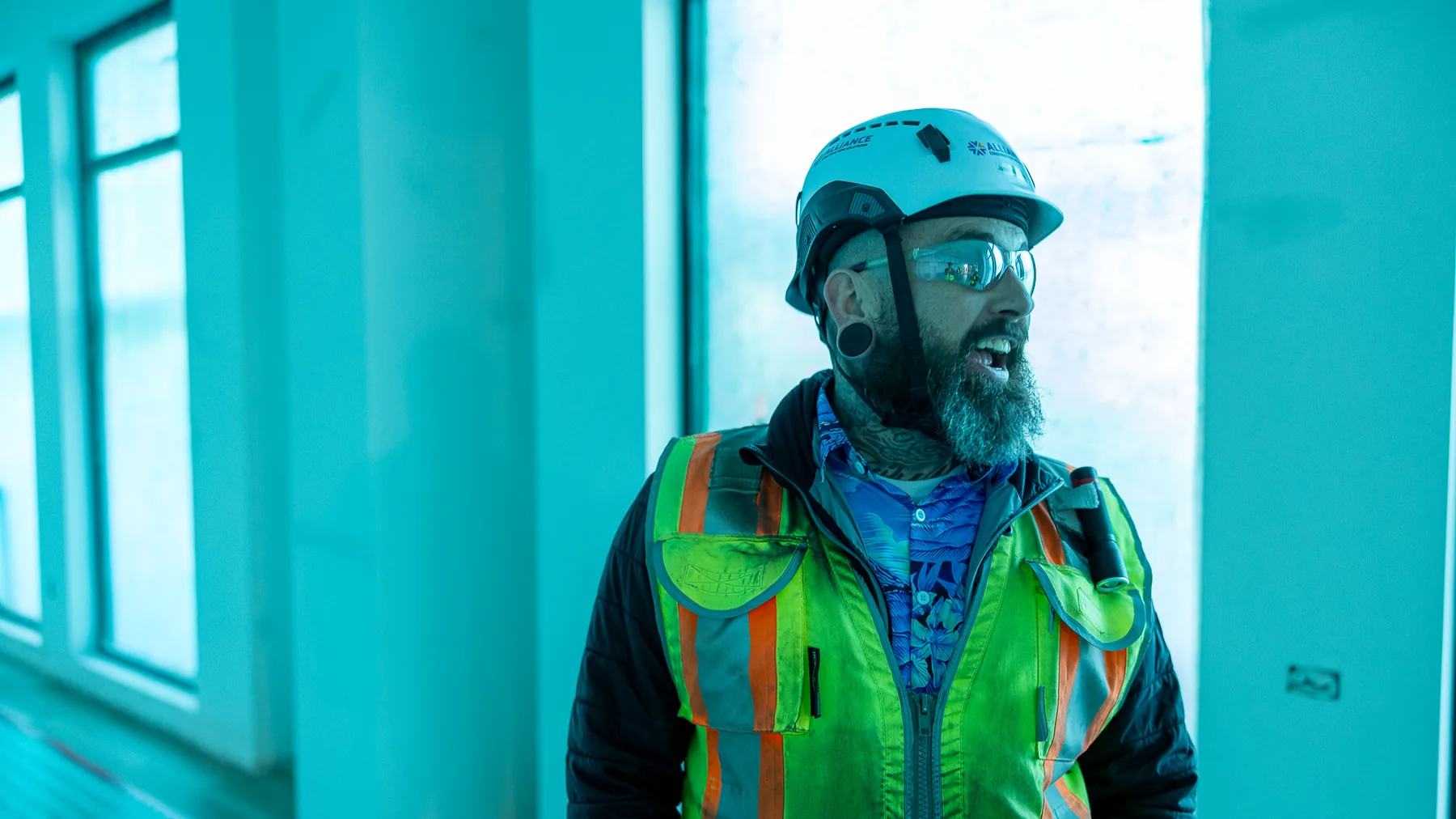 Tradesman in safety vest on an interior jobsite
