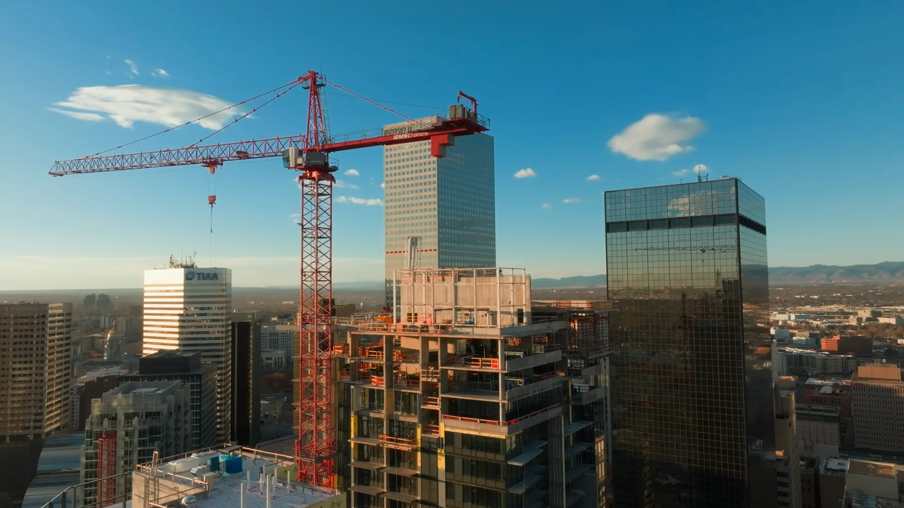 Tower crane over a downtown Denver construction site, aerial