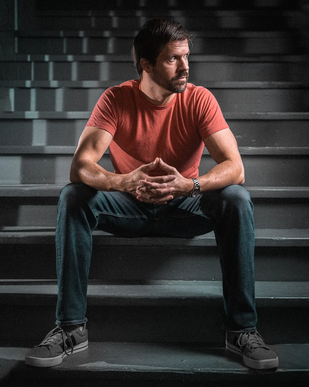 Environmental portrait seated on stadium steps
