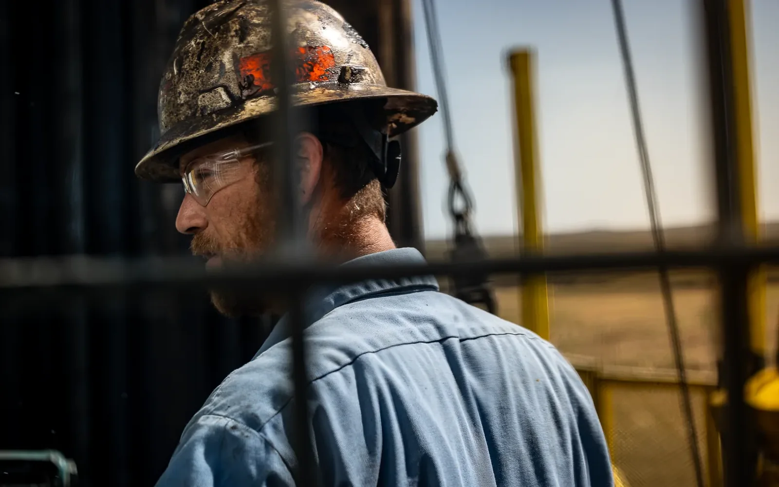 Anschutz Exploration driller in hard hat on the rig, environmental portrait